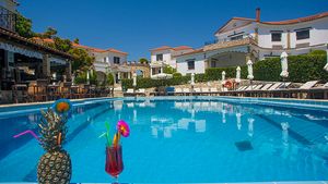 Erfrischender Pool, einladende Sonnenliegen und tropische Cocktails – perfekte Kulisse für entspannte Stunden in mediterraner Atmosphäre.